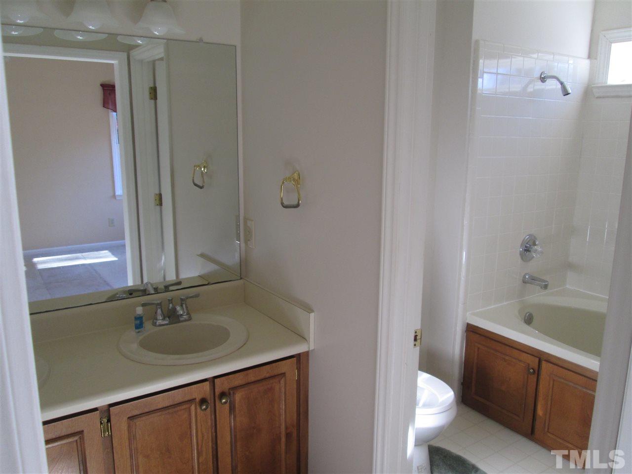 2600 Denbigh Court Raleigh, NC 27604 - Photo 10 of 13 a bathroom with a sink a toilet and shower