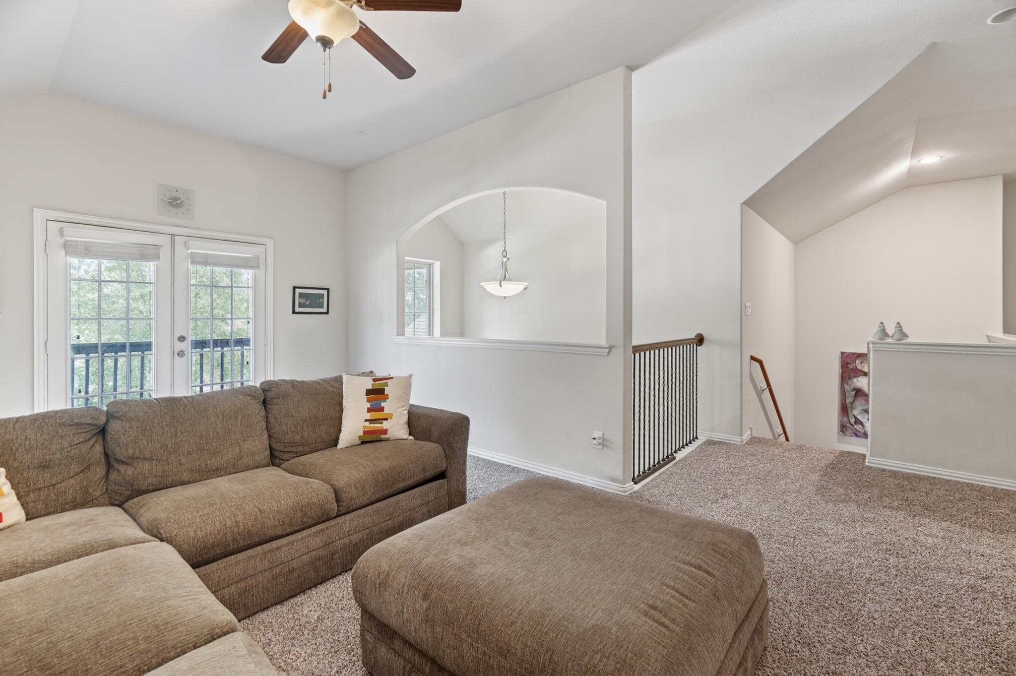 79 West Jagged Ridge Circle Spring, TX 77389 - Photo 30 of 50 From this angle, the upstairs family room's open archway and vaulted ceiling create a bright, airy feel that connects beautifully to the rest of the second floor. With plenty of room for seating and entertainment, this space is ready for game nights and gatherings alike.