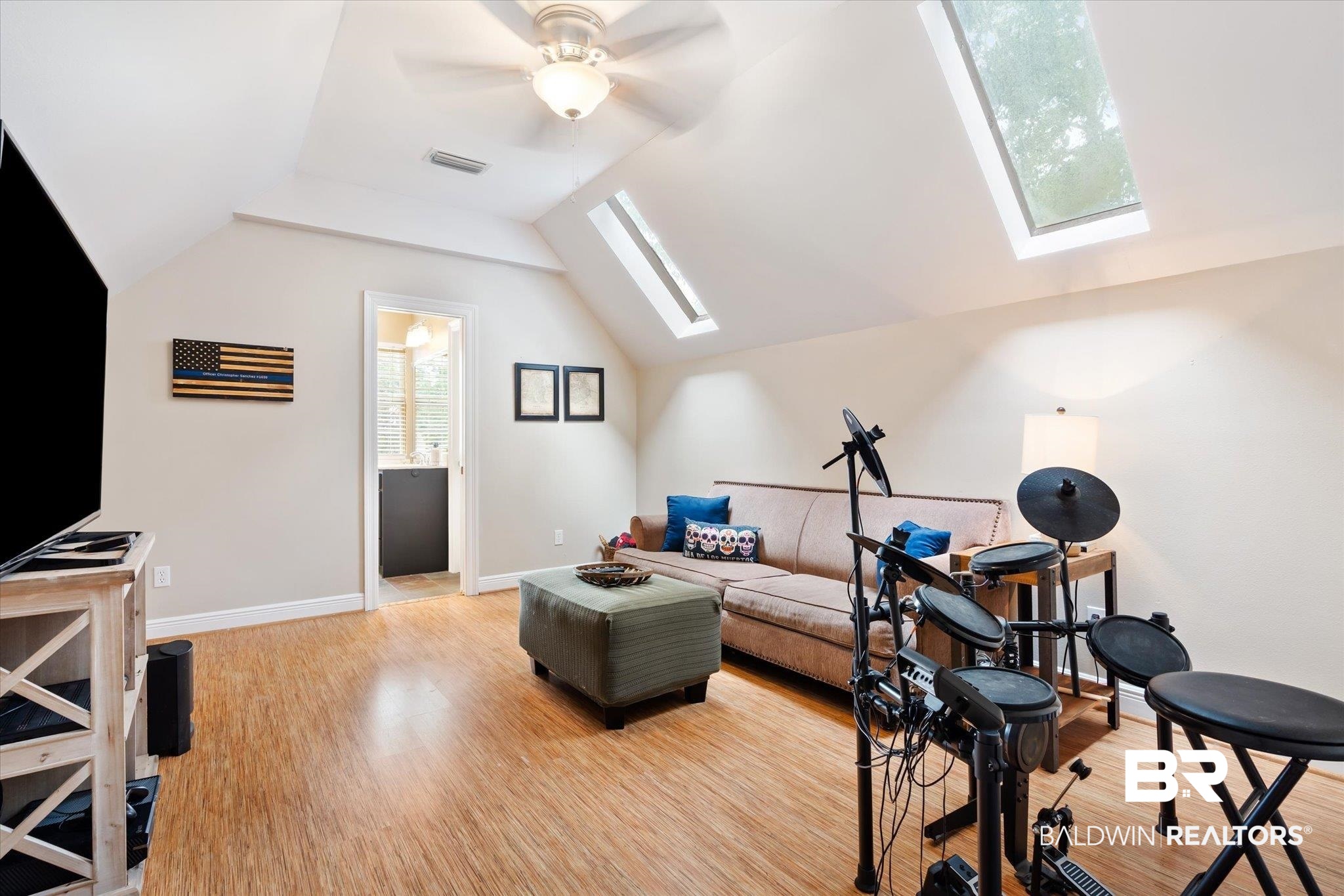 30648 Pine Court Daphne, AL 36527 - Photo 18 of 30 Exercise room featuring light hardwood / wood-style floors, vaulted ceiling with skylight, and ceiling fan