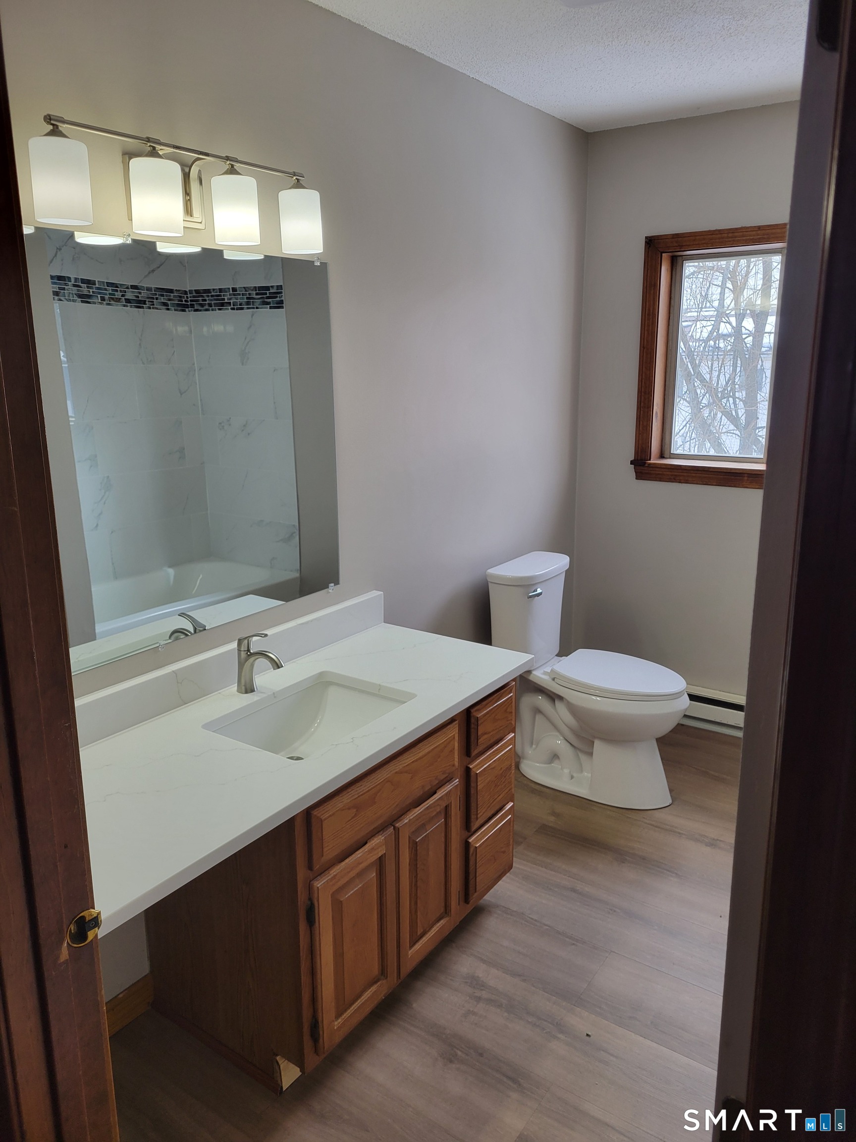 32 Stanley Street Naugatuck, CT 06770 - Photo 13 of 25 a bathroom with a granite countertop sink a toilet and mirror
