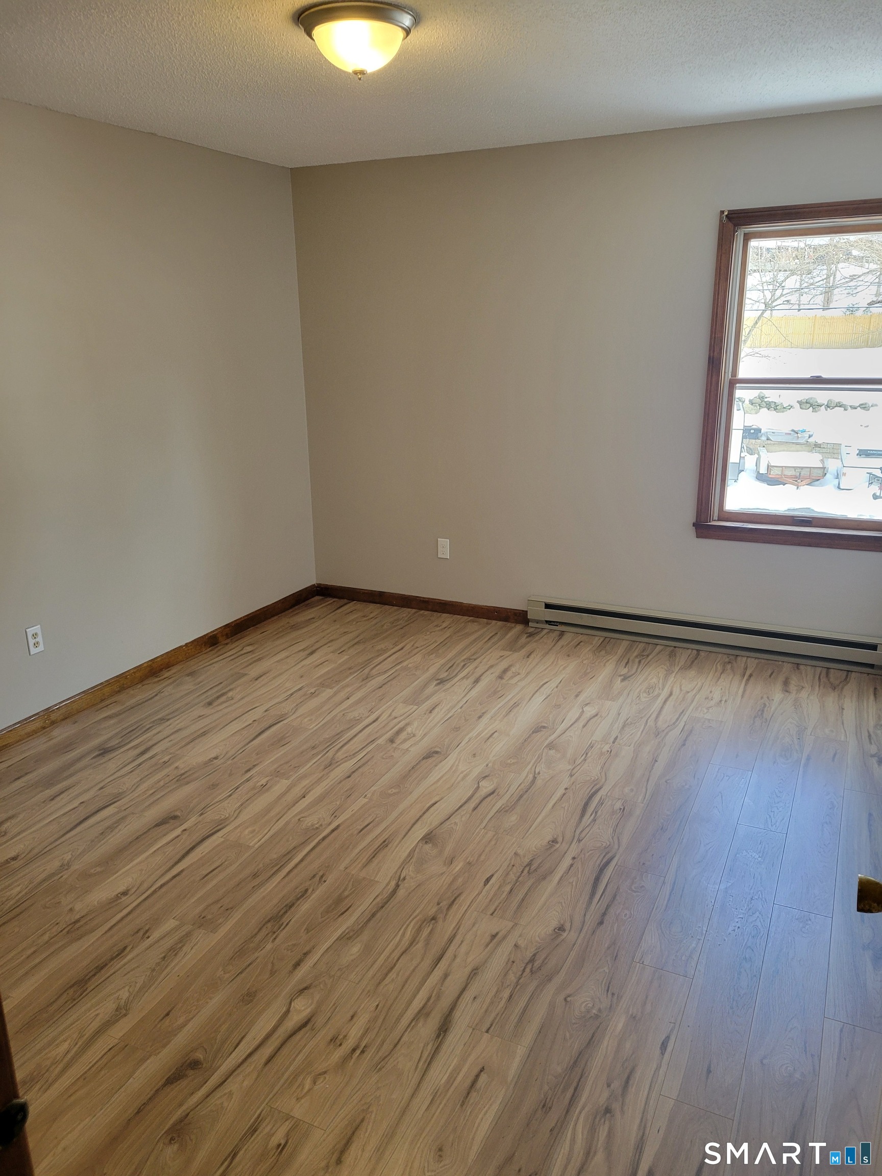 32 Stanley Street Naugatuck, CT 06770 - Photo 15 of 25 a view of an empty room with wooden floor and a window