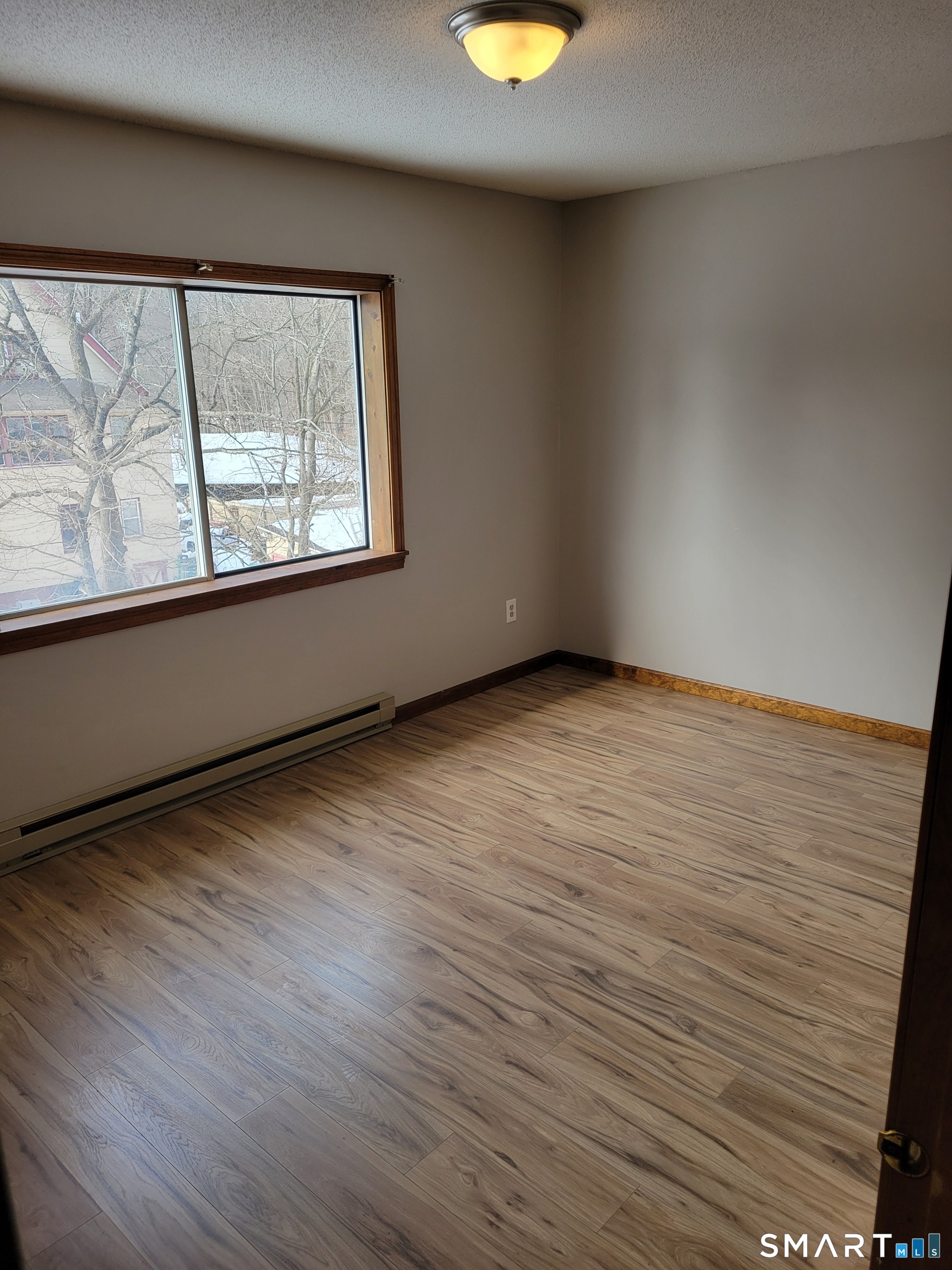 32 Stanley Street Naugatuck, CT 06770 - Photo 16 of 25 wooden floor in an empty room with a window