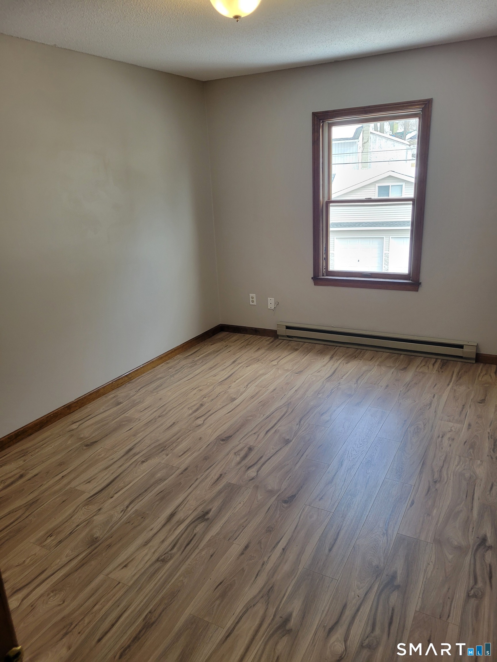 32 Stanley Street Naugatuck, CT 06770 - Photo 18 of 25 an empty room with wooden floor and windows