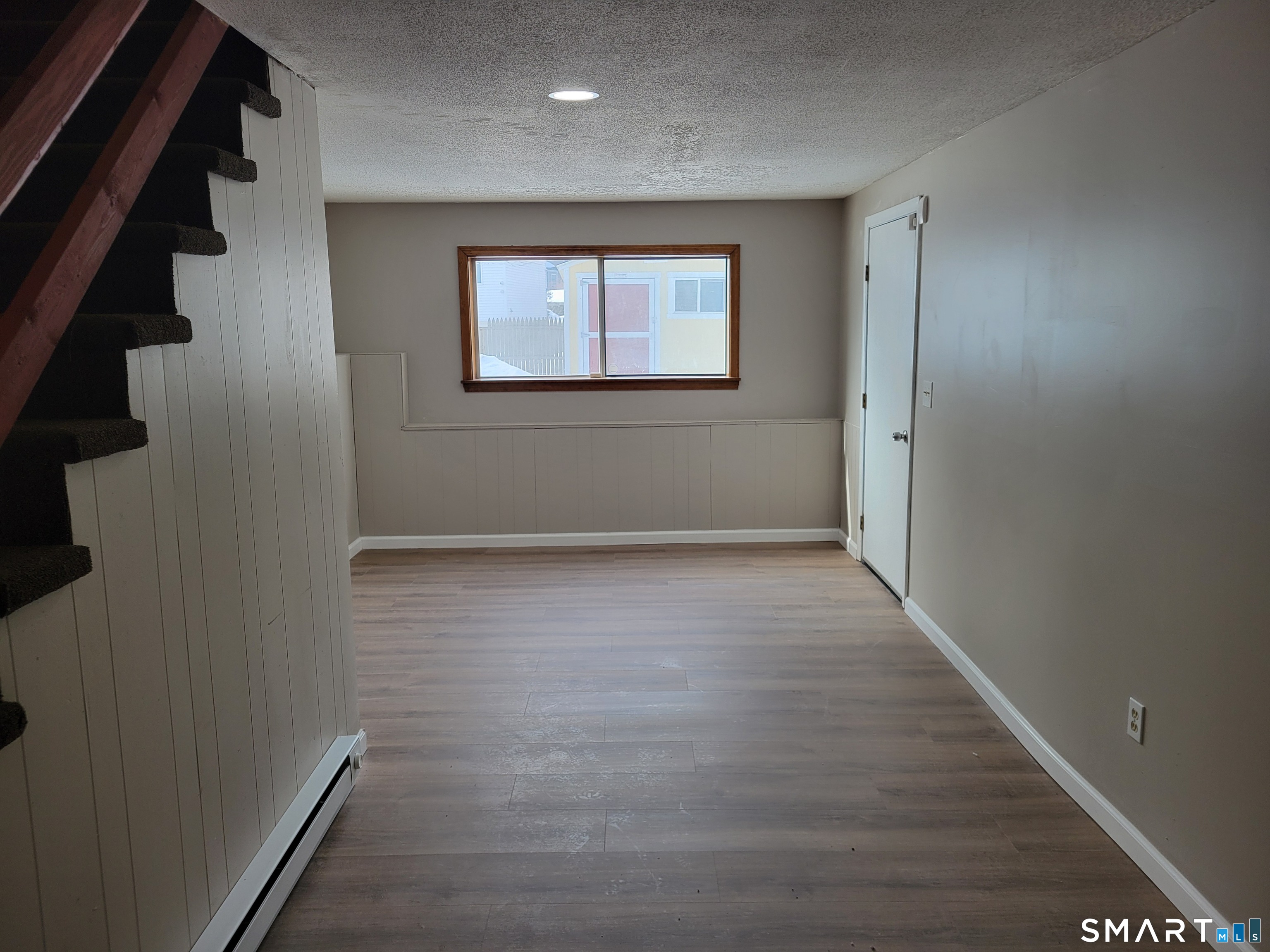 32 Stanley Street Naugatuck, CT 06770 - Photo 20 of 25 an empty room with wooden floor and windows