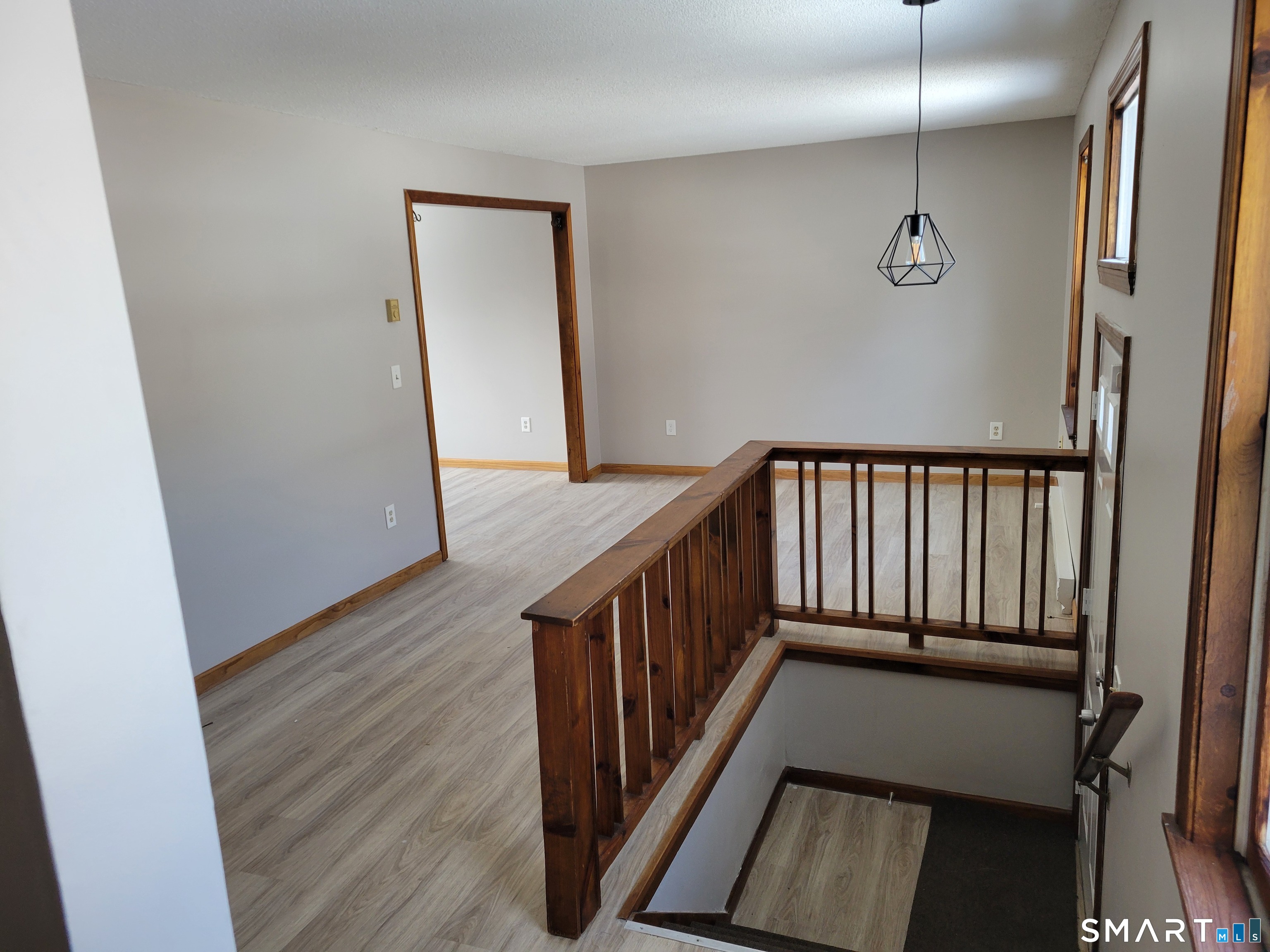 32 Stanley Street Naugatuck, CT 06770 - Photo 2 of 25 a view of a hallway with wooden floor and stairs