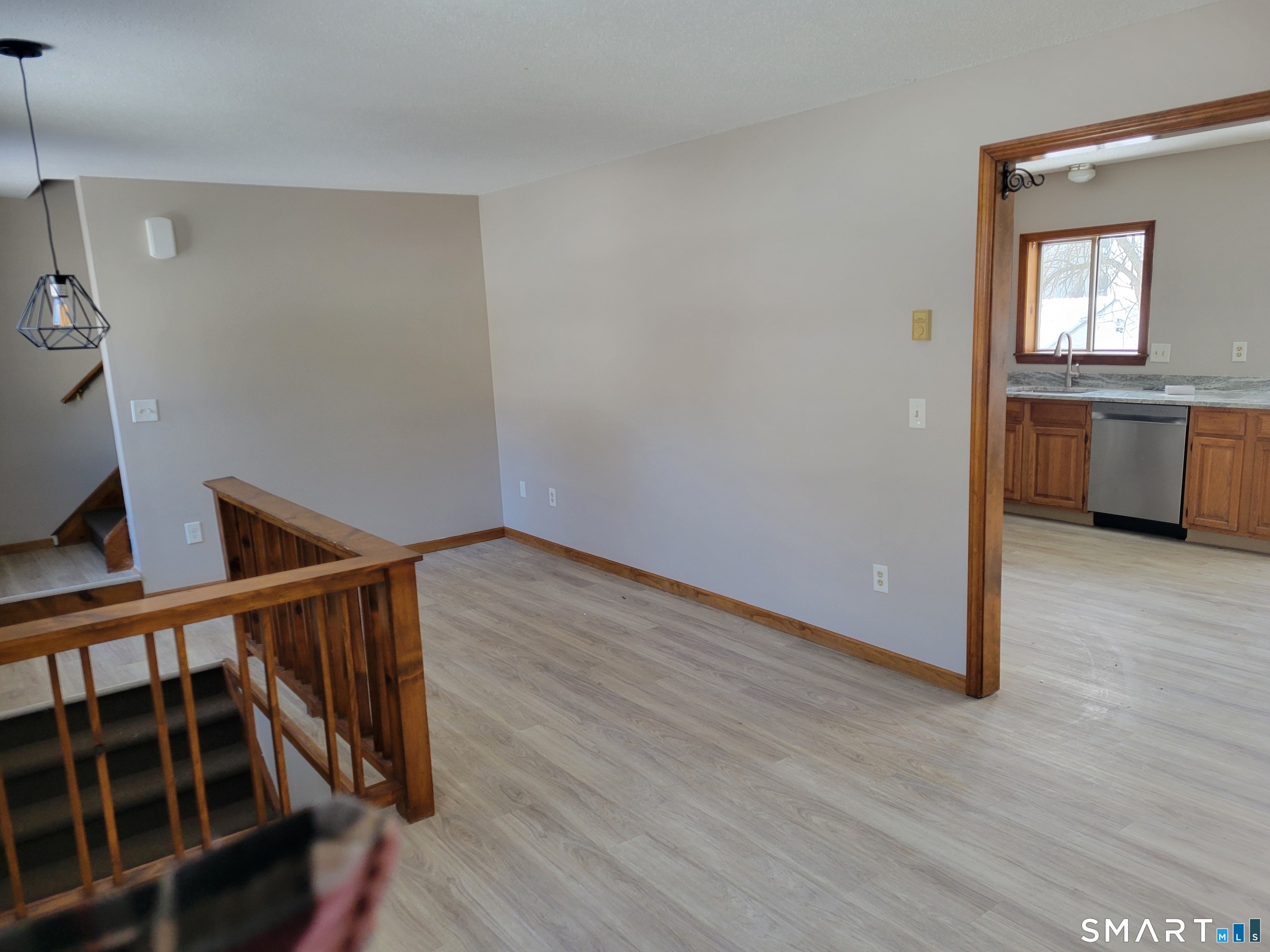 32 Stanley Street Naugatuck, CT 06770 - Photo 3 of 25 a view of a hallway with wooden floor and kitchen