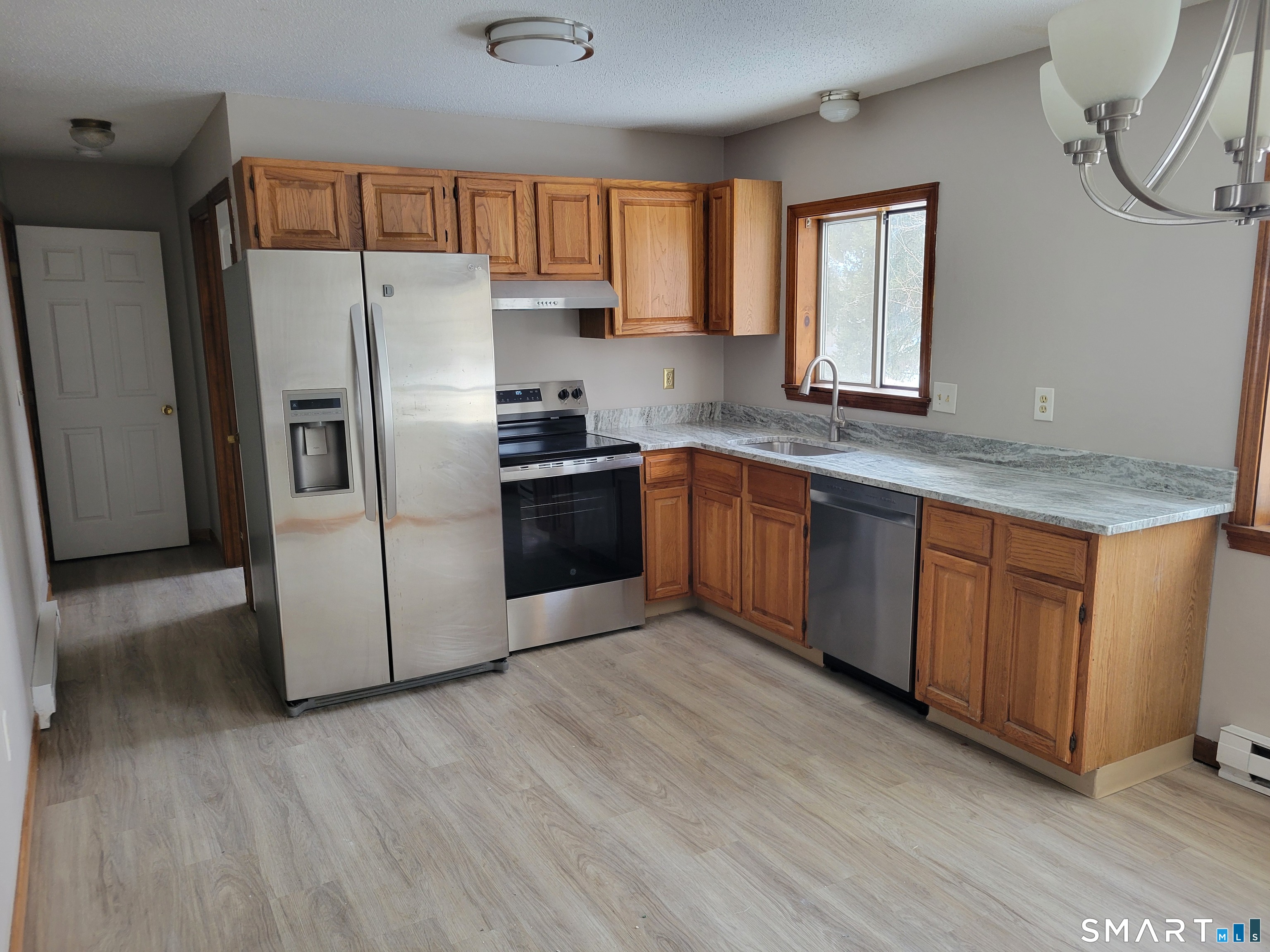32 Stanley Street Naugatuck, CT 06770 - Photo 6 of 25 a kitchen with stainless steel appliances granite countertop a refrigerator a sink dishwasher a stove with wooden cabinets