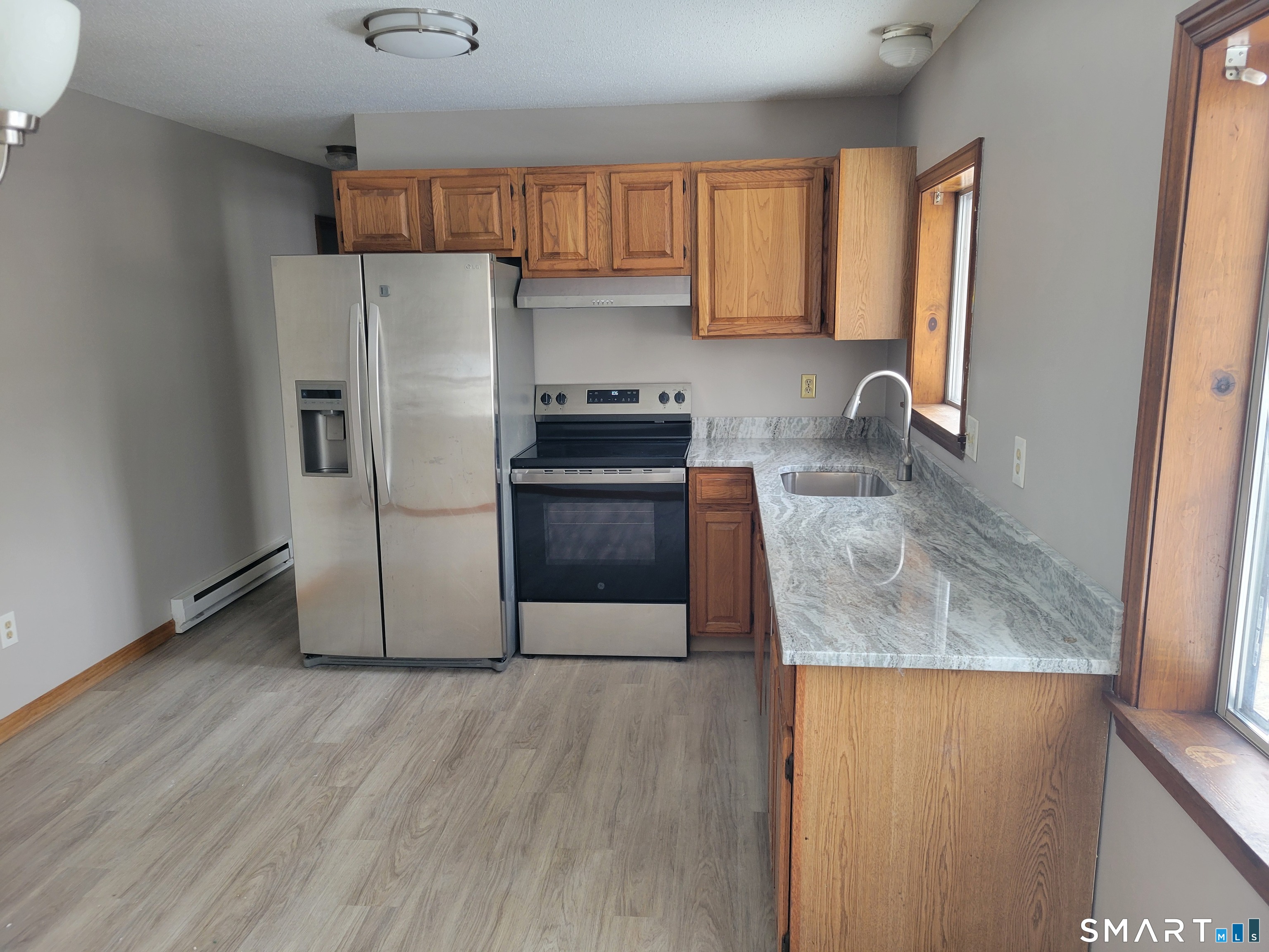 32 Stanley Street Naugatuck, CT 06770 - Photo 7 of 25 a kitchen with granite countertop a refrigerator sink and stove