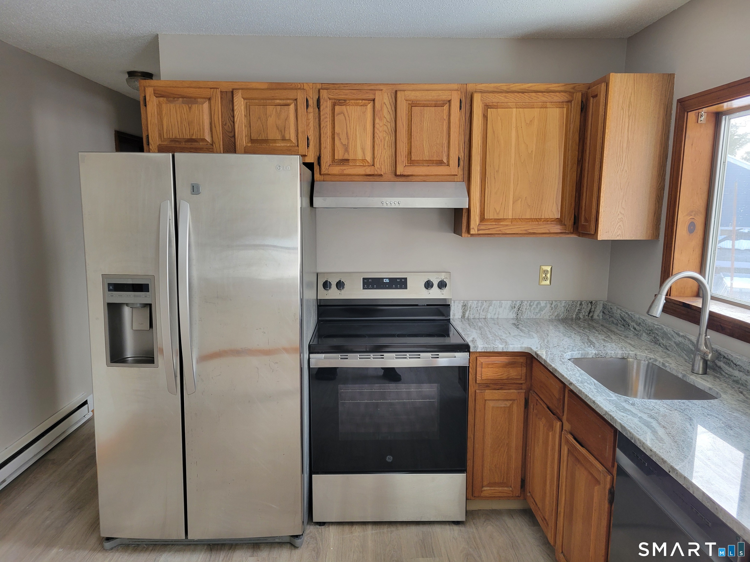 32 Stanley Street Naugatuck, CT 06770 - Photo 8 of 25 a kitchen with a refrigerator sink and cabinets