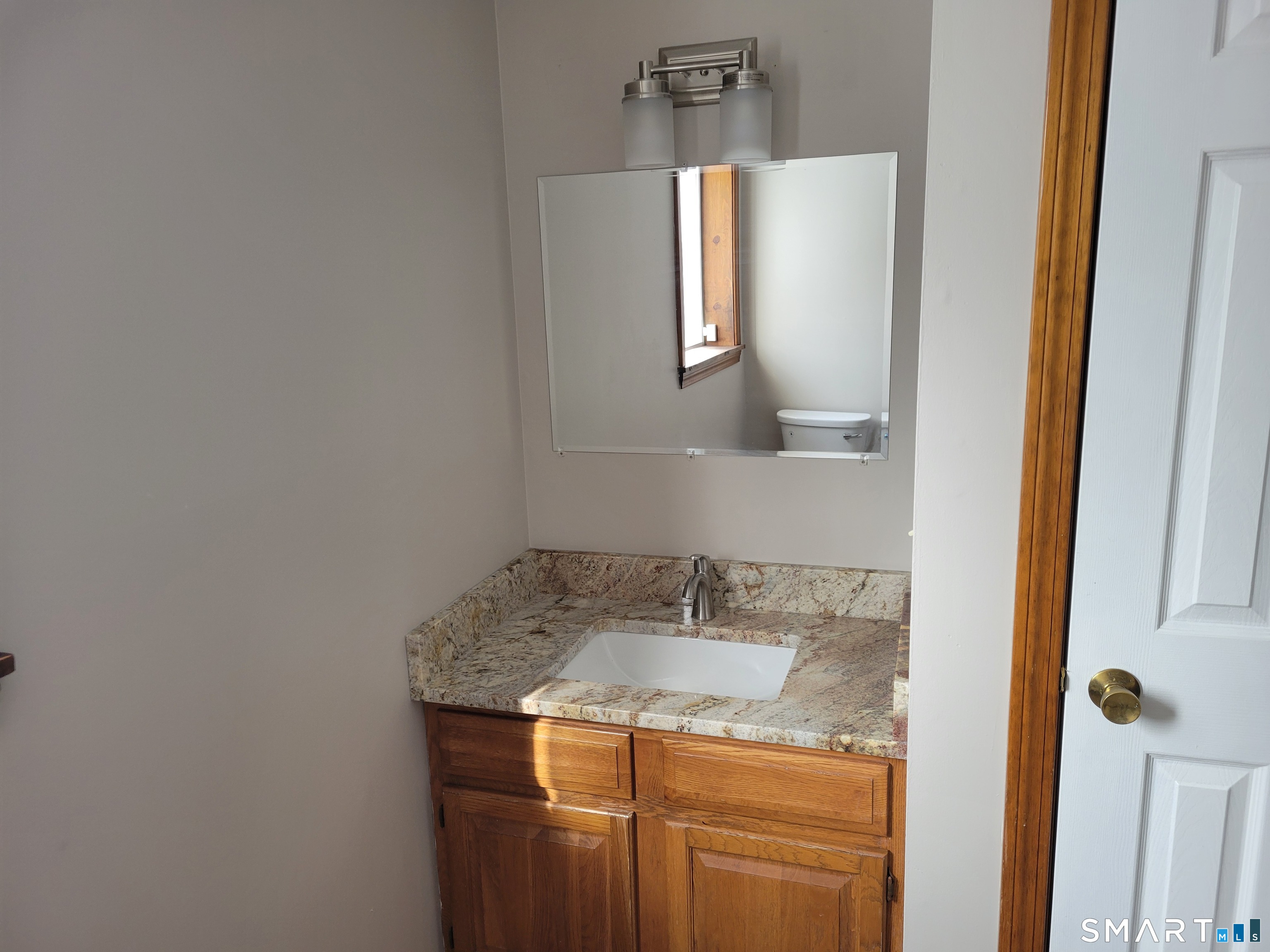 32 Stanley Street Naugatuck, CT 06770 - Photo 10 of 25 a bathroom with a granite countertop sink and a mirror