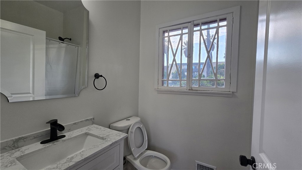 1040 Beacon Avenue, Unit 1040 Los Angeles, CA 90015 - Photo 8 of 8 a bathroom with a sink and a window