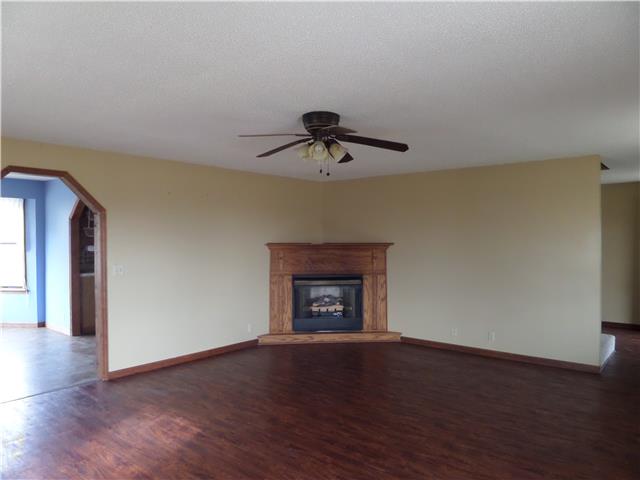 1299 Charley Davis Road Goodspring, TN 38460 - Photo 10 of 20 Large Living Room with Gas Fireplace and laminate flooring