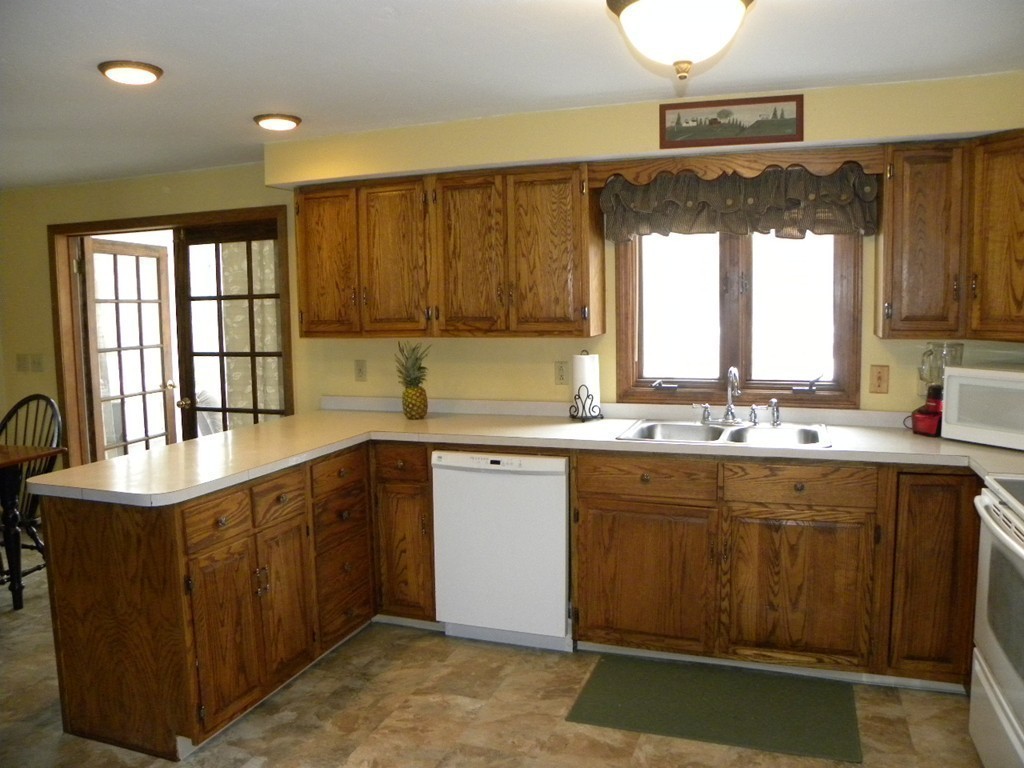 129 Old Worcester Road Charlton, MA 01507 - Photo 14 of 30 a kitchen with a sink stove and cabinets