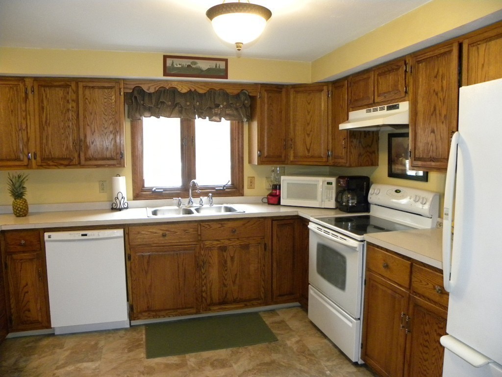 129 Old Worcester Road Charlton, MA 01507 - Photo 17 of 30 a kitchen with a sink stove and cabinets