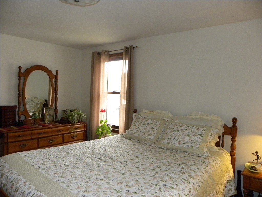 129 Old Worcester Road Charlton, MA 01507 - Photo 18 of 30 a bedroom with a bed and a dresser with mirror