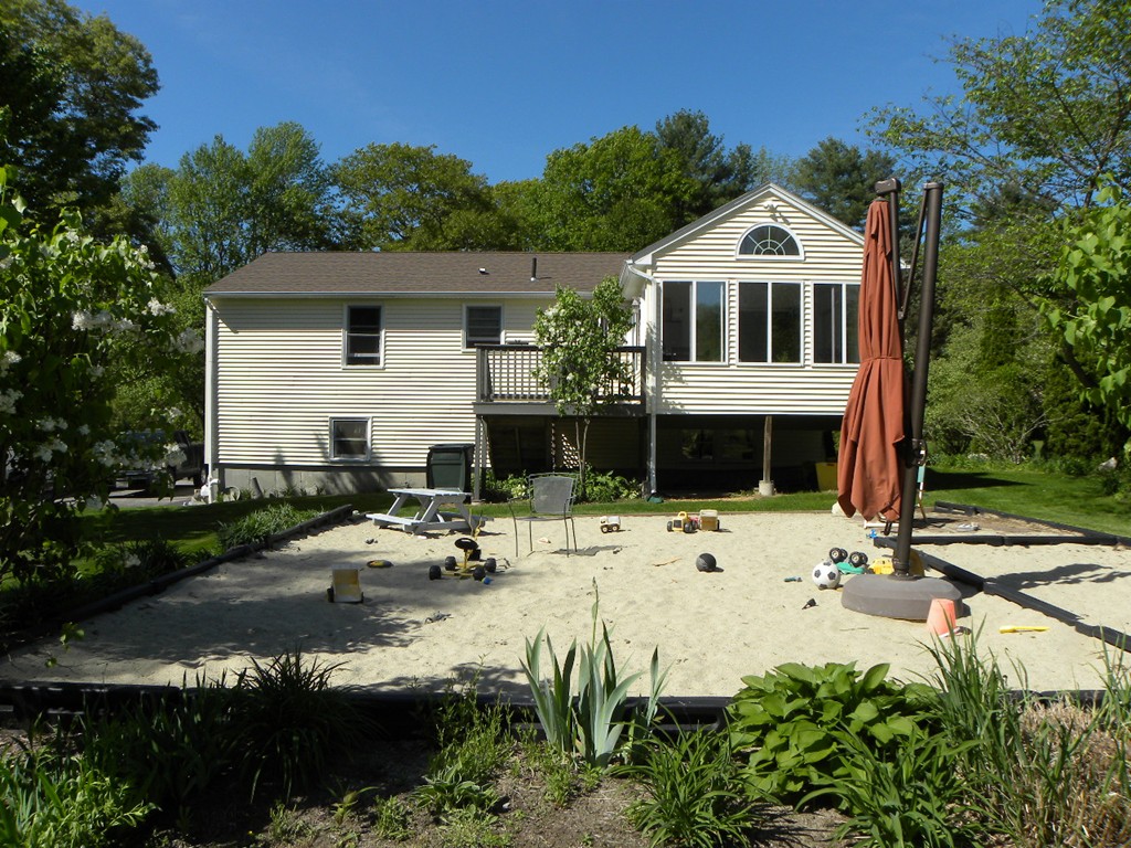 129 Old Worcester Road Charlton, MA 01507 - Photo 24 of 30 a view of a white house with a yard and lawn chairs with plants