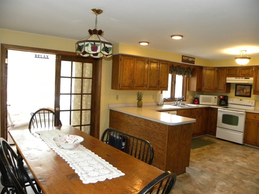 129 Old Worcester Road Charlton, MA 01507 - Photo 4 of 30 a kitchen with kitchen island granite countertop a sink stove and cabinets
