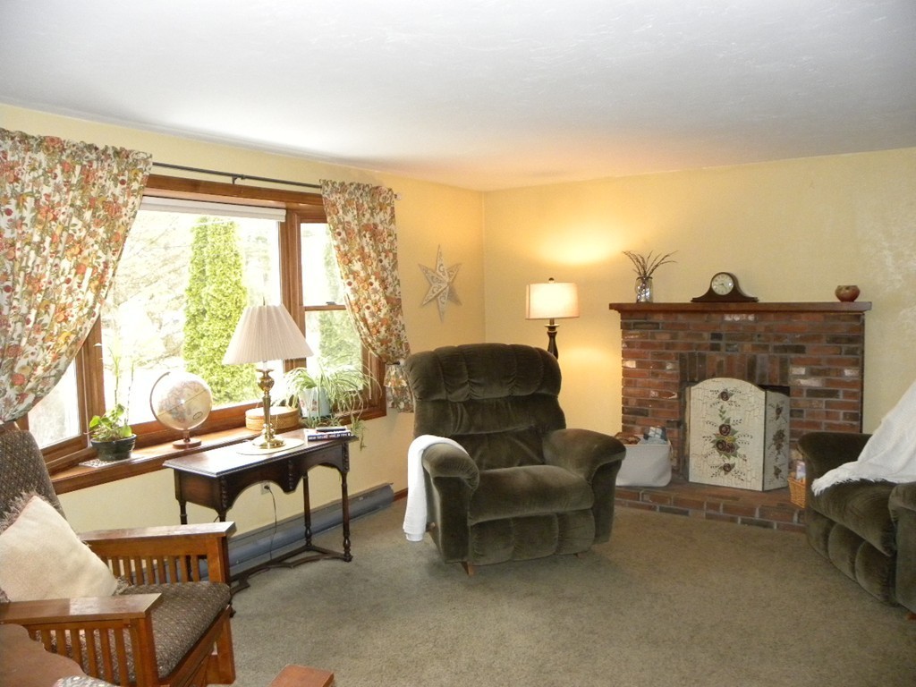 129 Old Worcester Road Charlton, MA 01507 - Photo 7 of 30 a living room with furniture and a fireplace