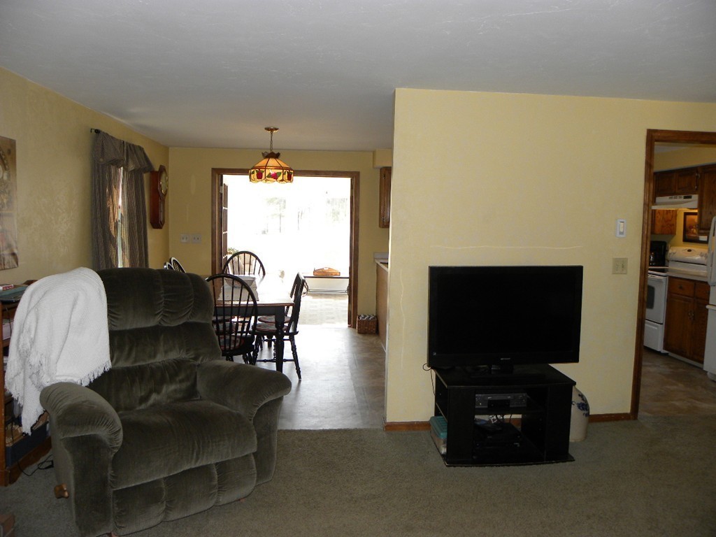 129 Old Worcester Road Charlton, MA 01507 - Photo 8 of 30 a living room with furniture a flat screen tv and a fireplace