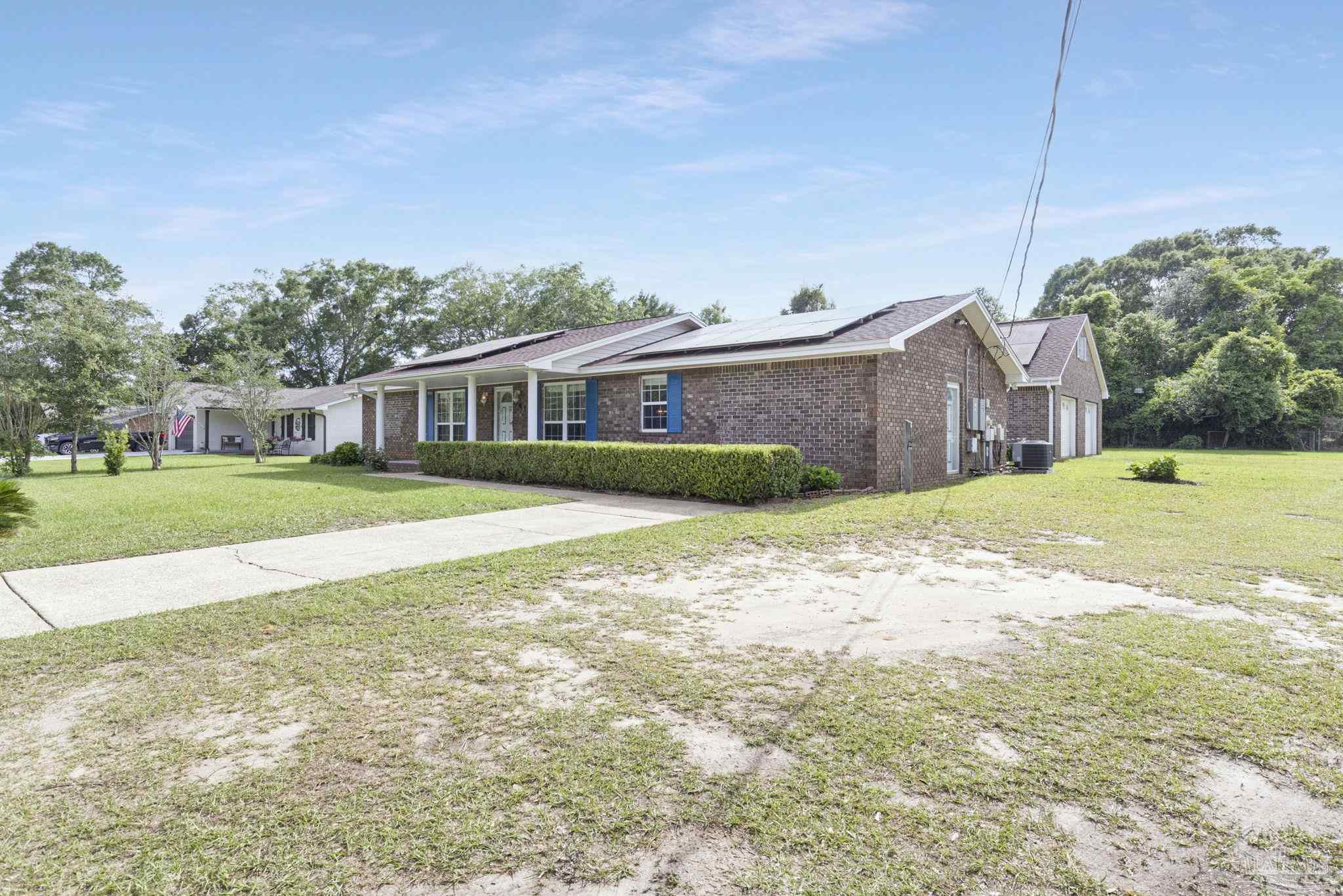 4411 Pace Lane Pace, FL 32571 - Photo 6 of 68 a view of a house with a big yard and large trees