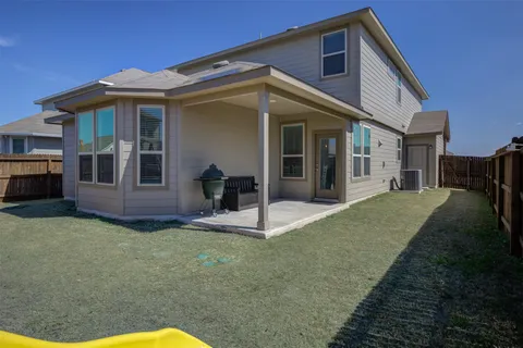 a view of a house with backyard and porch
