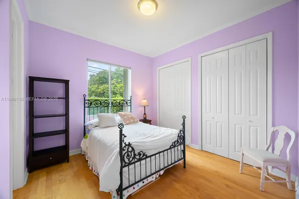 a bed room with a bed and a chair
