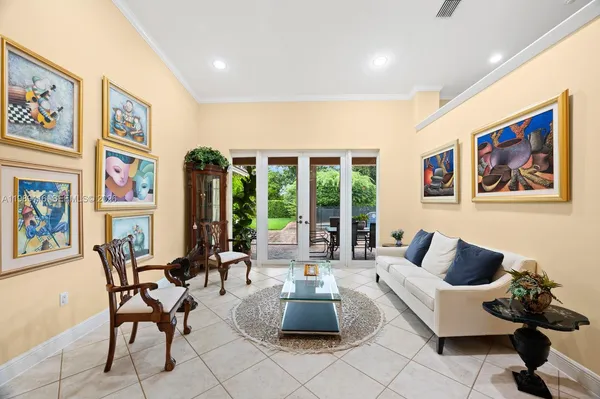 a living room with furniture and large windows