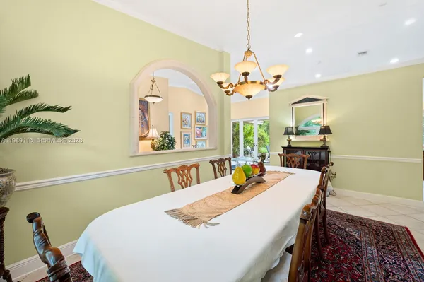 a view of a dining room with furniture and a chandelier