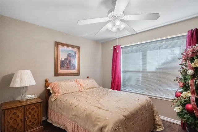 a bedroom with a bed and a potted plant