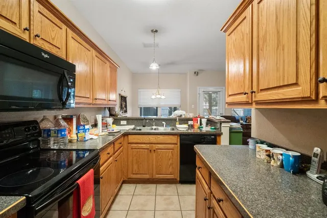a kitchen with a sink a stove and cabinets