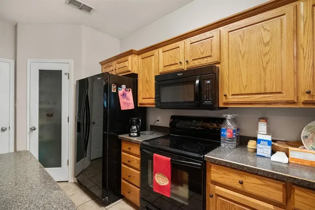 a kitchen with stainless steel appliances granite countertop a stove and a microwave