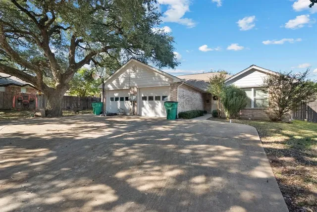a view of a white house with a yard