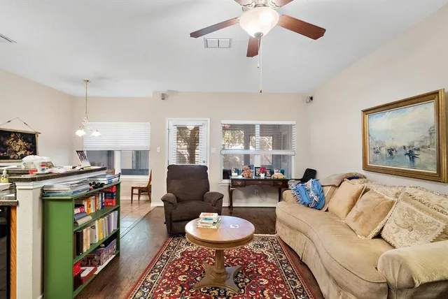 a living room with furniture and a wooden floor