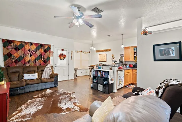a living room with fireplace furniture and a flat screen tv