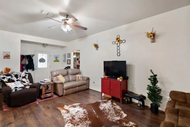 a living room with furniture and wooden floor