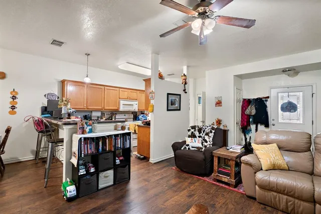 a living room with furniture and wooden floor