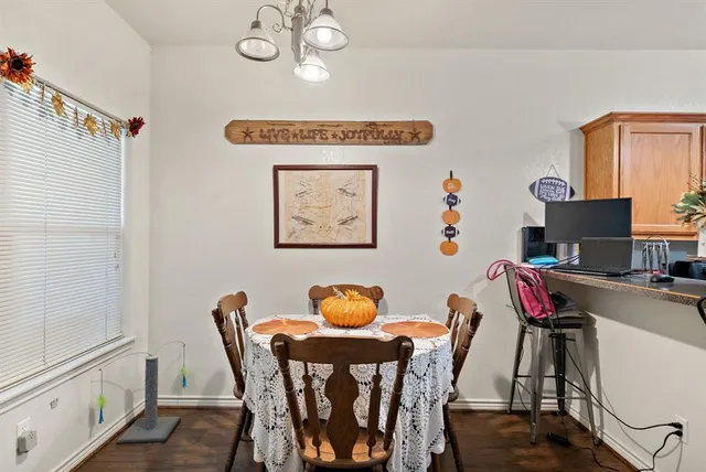 a view of a dining room with furniture and a chandelier