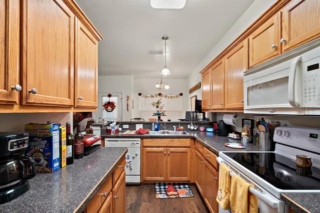 a kitchen with lots of counter top space and wooden floor