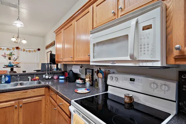 a kitchen with stainless steel appliances granite countertop a sink stove and cabinets