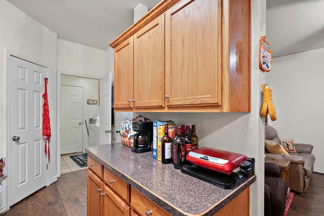 a kitchen with stainless steel appliances granite countertop a sink a stove and a refrigerator