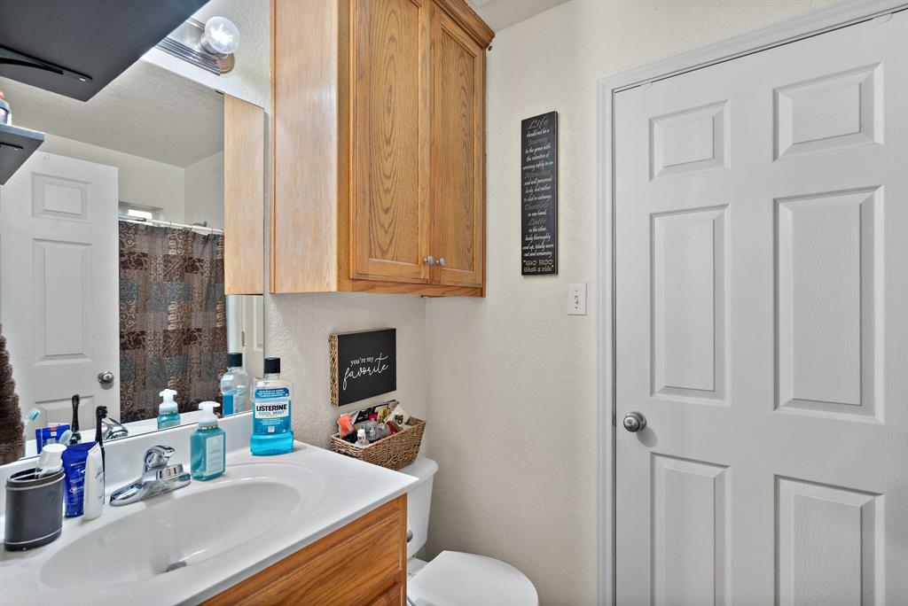 1155 Cage Street Stephenville, TX 76401 - Photo 38 of 38 a bathroom with a sink a toilet and shower