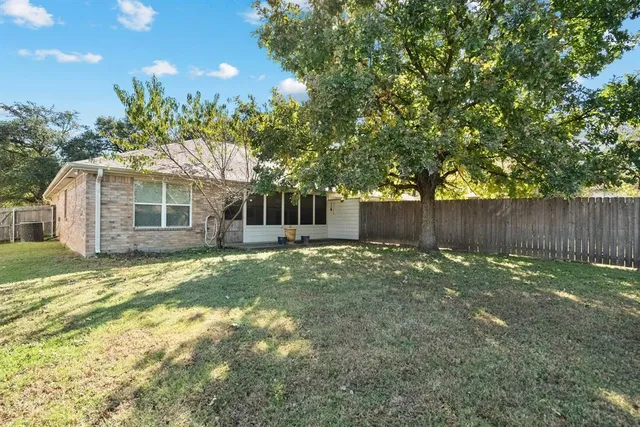 a backyard of a house with table and chairs