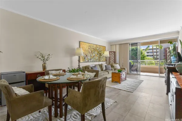 a dining room with furniture and a large window