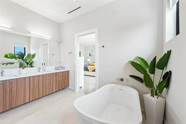 a bed room with a bed and a large window