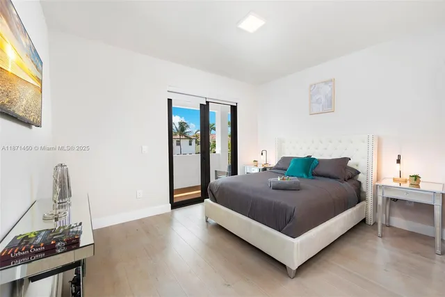 a bedroom with a bed and blue lamp on the dresser