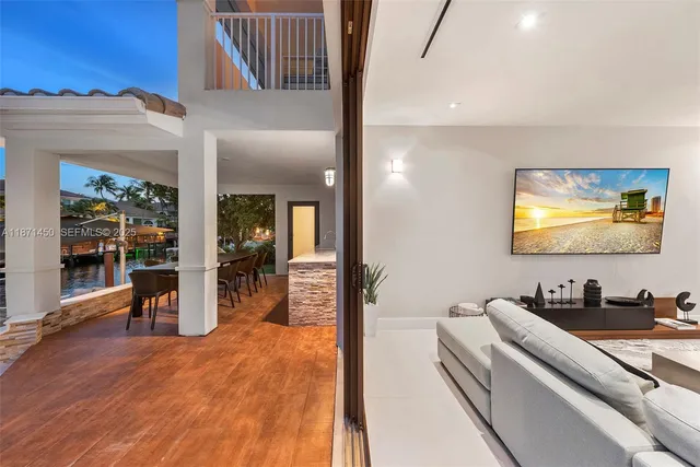 a view of a dining room with furniture a rug and potted plants