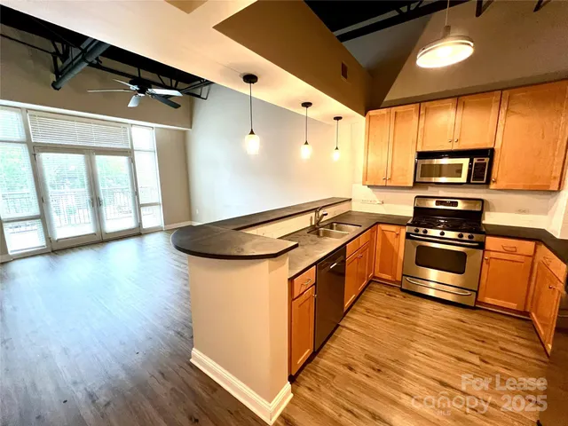 a view of a room with wooden floor and windows