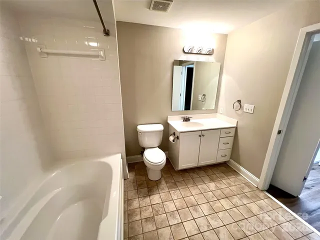 a view of building with swimming pool and furniture