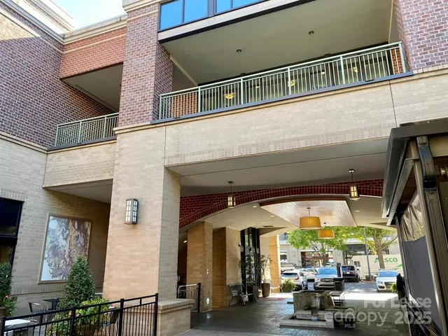 a living room with furniture a fireplace and a floor to ceiling window