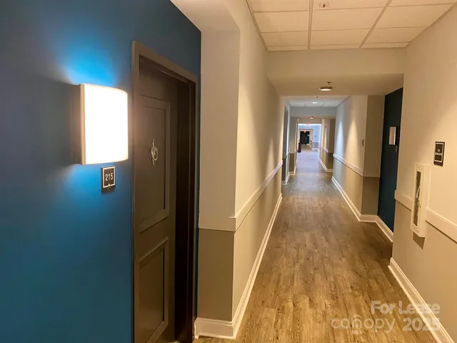 a view of a hallway with wooden floor